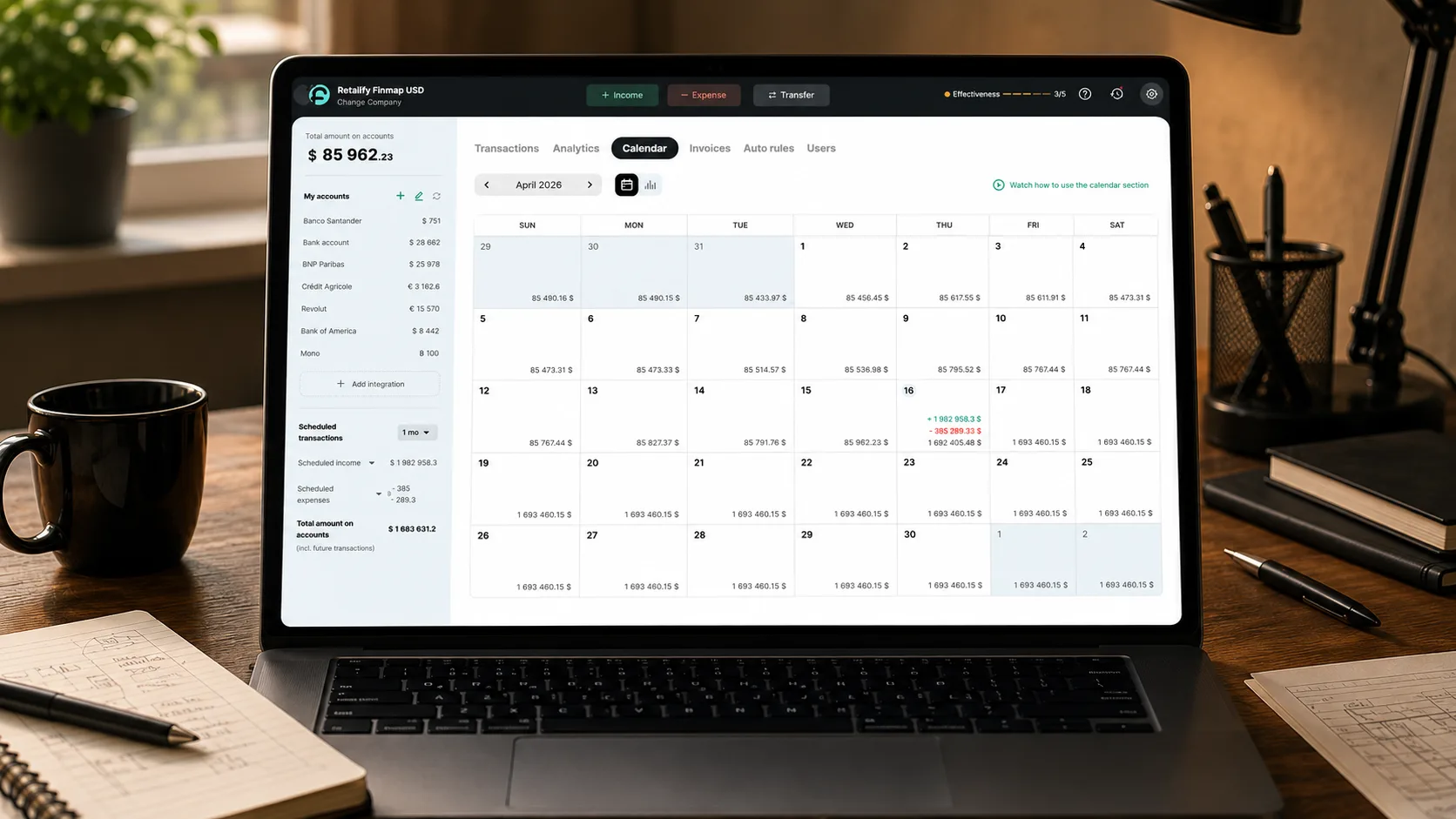 Tablet device showing a 30-day payment calendar dashboard, propped on top of a folded technical drawing with a pencil resting beside it, warm afternoon sunlight from the window