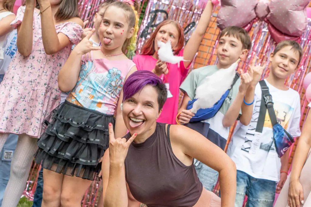Yana Moskovchenko dancing and having fun with children during a summer party at ThinkGlobal school.
